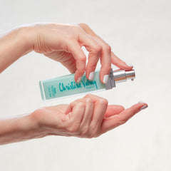 Christine Valmy's all-natural Ecran: Daytime Protection & Moisturizing Lotion held horizontally by hands