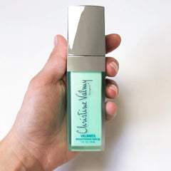 Christine Valmy's all-natural Valbrite: Fast-Acting Brightening Serum held vertically by hands