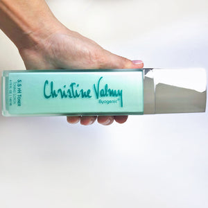 Christine Valmy's all-natural 5.5 pH Toner being held horizontally by a hand