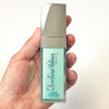 Christine Valmy's all-natural Q Serum: Oily Skin Correcting Serum being held by a hand